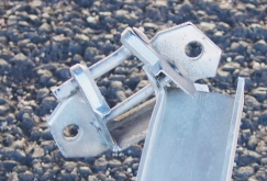 Photo of a broken bracket and support arm.